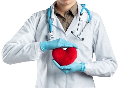 Premium Photo | Close up group of doctor and nurse hands holding red heart together for patient ...