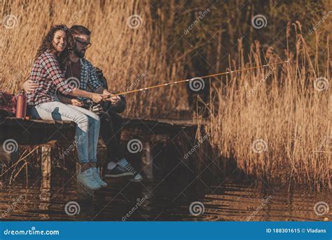 Couple fishing by the lake stock image. Image of girl - 188301615