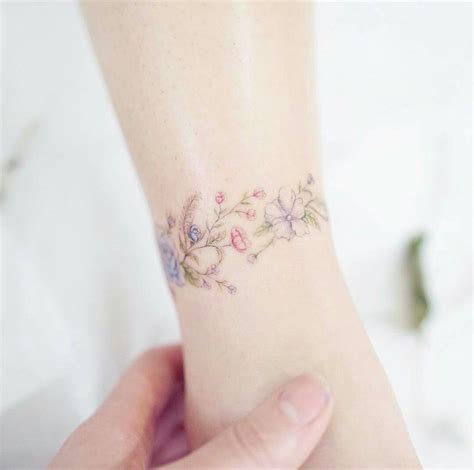 Flower Bracelet Tattoo | Tattoos for daughters, Tiny tattoos, Dainty tattoos