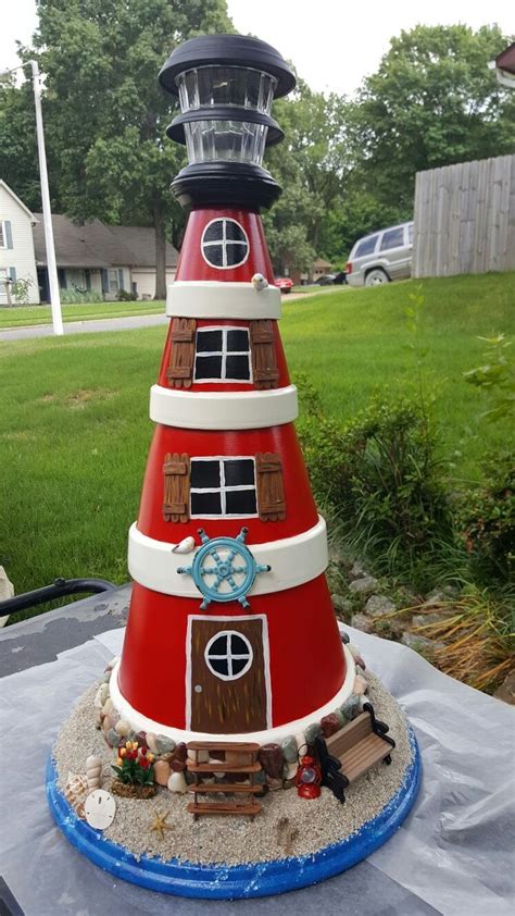 a red and white lighthouse on top of a table