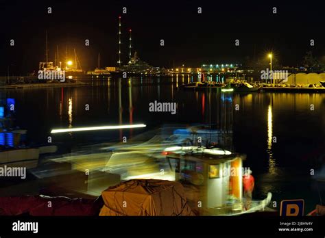 Fishing boat manoeuvring at night in the harbour Stock Photo - Alamy