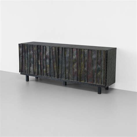 Lot 132: Paul Evans. cabinet. 1968, welded and patinated steel, lacquered wood. 84 w x 20½ d x ...