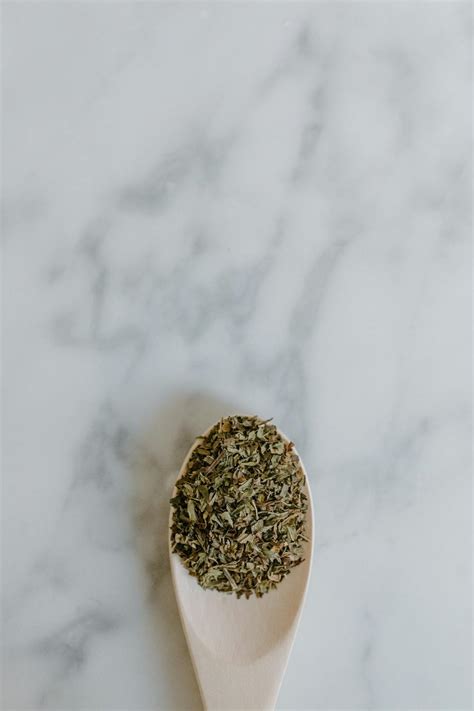 Dried green tea leaves in spoon on table · Free Stock Photo