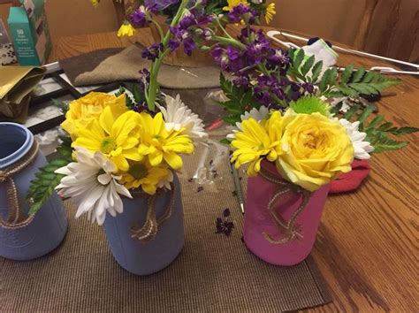Two of the mason jars I painted and flower arrangements I created ...