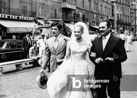 Candice Bergen in a wedding gown accompanied by two men by