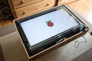 an open box on the floor with a computer screen in it's bottom compartment