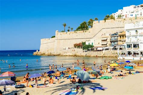 People Having Fun in Water and Relaxing in Peniscola Beach Resort at Mediterranean Sea in Spain ...