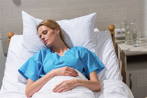 sick woman sleeping on hospital bed - Stock Photo - Dissolve