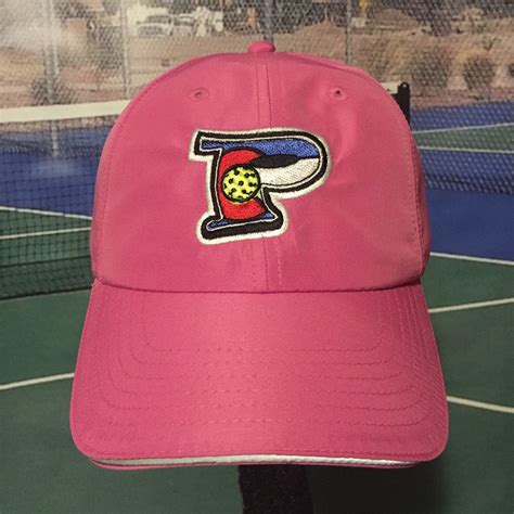 Pink cool fit hat with P is for Pickleball logo. Reflective seam on brim and tag on back. Are ...