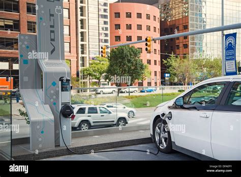 A Chevrolet Volt electric car plugged in to a charging station outside ...