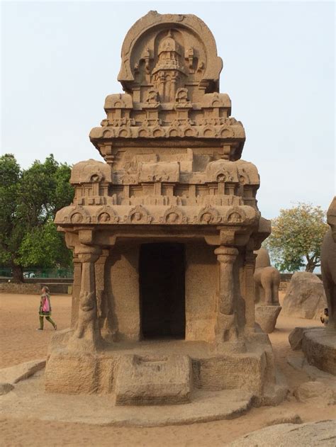 an old stone structure sitting in the middle of a dirt field with ...