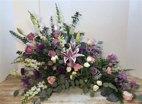 A20 -Asymmetrical Flower arrangement to go behind a cremation urn for a fune… | Funeral flower ...