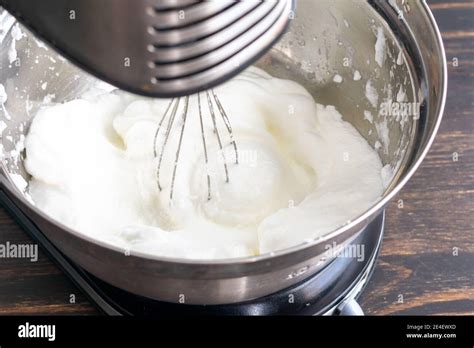 Whisking Egg Whites to Make Meringue: Egg whites that have been beaten ...