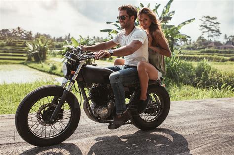 Young couple enjoying motorcycle ride on country road stock photo ...