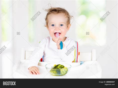 Baby Eating Vegetables Image & Photo (Free Trial) | Bigstock