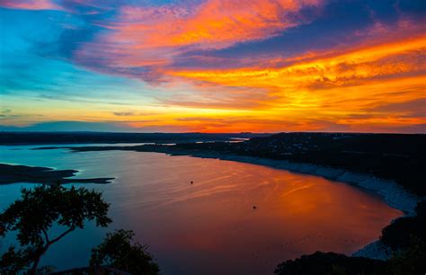 Dramatic Sun sets over Travis Lake in Austin Texas - SITE