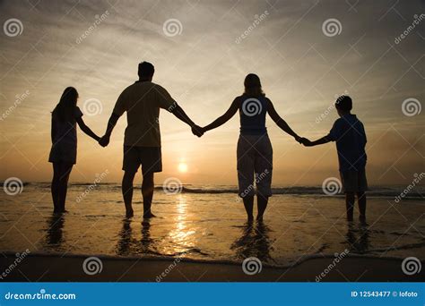 Family Holding Hands on Beach Watching the Sunset Stock Image - Image ...