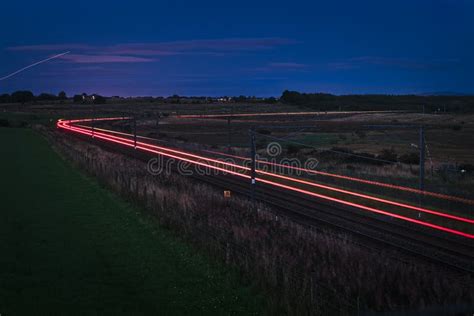 Passenger Train on Railroad Tracks at Night Stock Photo - Image of night, speed: 135290452