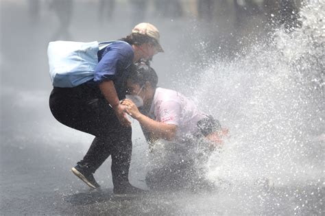 Water cannons and batons at protest against government’s handling of the pandemic