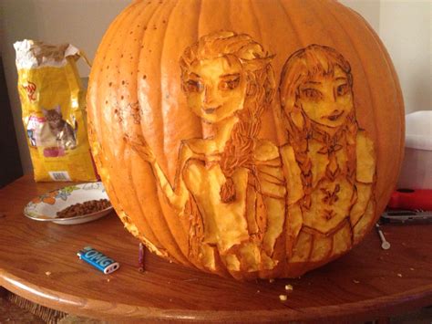 a carved pumpkin with two women on it