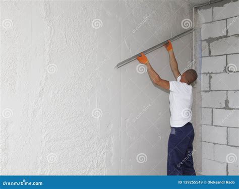 Worker Plastering House Walls, Finishing Walls. Wall Screeding. Plastering Walls Techniques ...