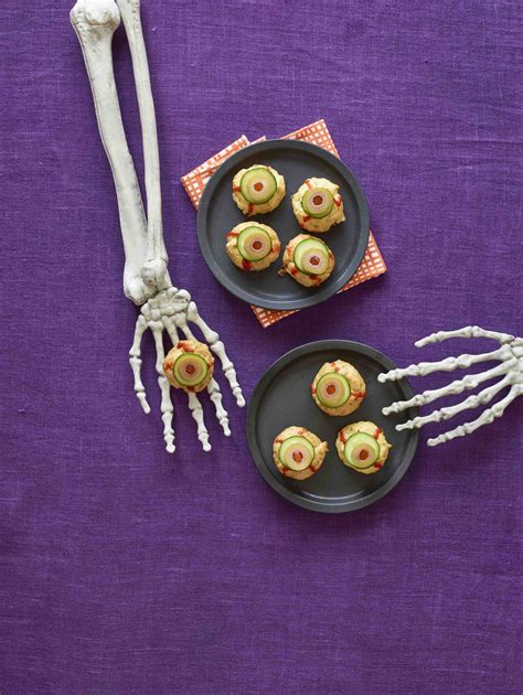 Cheese puff eyeballs with pimento stuffed olives and sriracha #halloweenfoodideas # ...