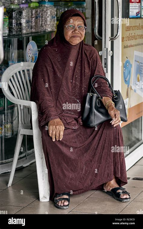 Elderly Muslim woman wearing the traditional Burka dress covering Stock ...