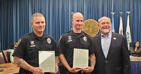 Rock Island Officers Zachary Costas, Andrew Lawler and Mayor Mike Thoms