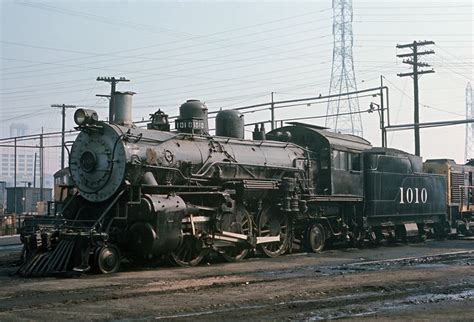 an old train is parked on the tracks in front of some power lines and telephone poles