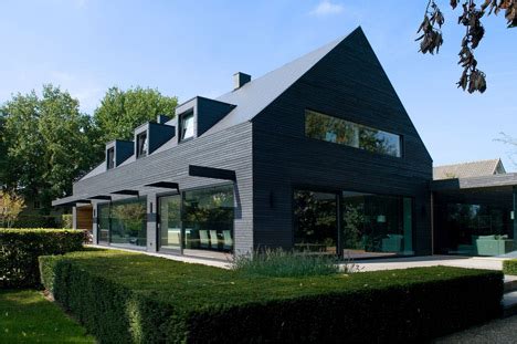 Dark grey cladding of timber panels and tiles to upgrade houses