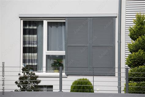 Windows with modern sliding shutters Stock Photo | Adobe Stock