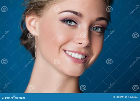 Young Smiling Woman Face on Blue Background Stock Image - Image of ...