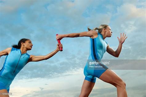 Runners passing baton in relay race | Relay races, Sport portraits, Track and field