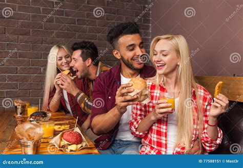 People Group Eating Fast Food Burgers Sitting at Wooden Table in Cafe Stock Image - Image of ...