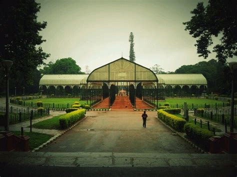 a person standing in front of a large building with a long walkway ...