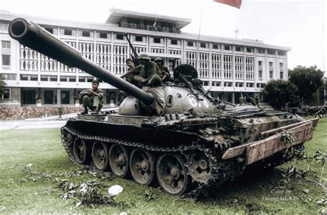 A North Vietnamese T-54/55 tank and its crew resting on the front lawn ...