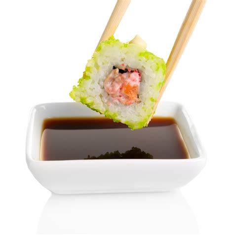 Premium Photo | Dipping roll in sauce isolated on white