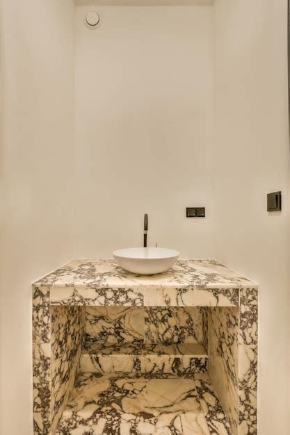 Premium Photo | A bathroom with a sink and a marble counter top