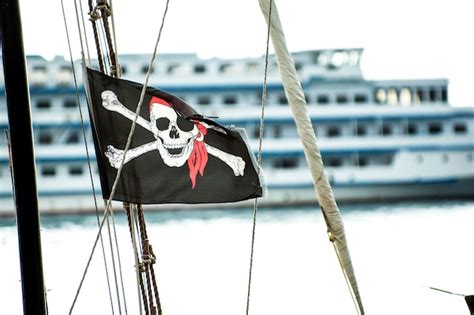 Premium Photo | Pirate flag on the background of the ship