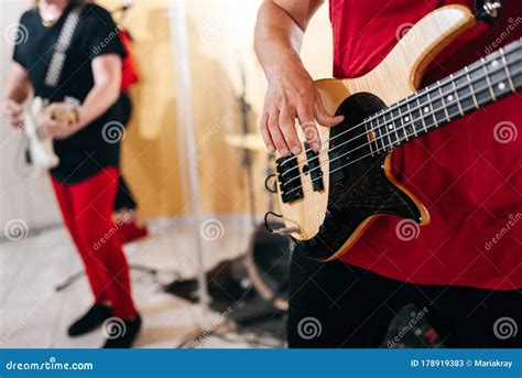 Rock Band Studio Rehearsal. Male Musician Playing Bass Guitar before ...