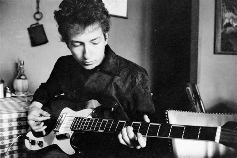 Bob Dylan plays a bass guitar in a restaurant, 1964 - Old Pictures