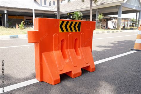 Orange water barrier on road, water-filled plastic barriers. Stock ...