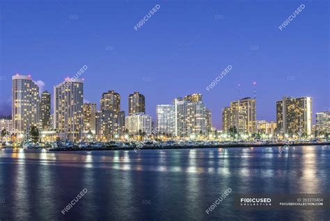 Honolulu city skyline reflection in ocean, Hawaii, United States ...