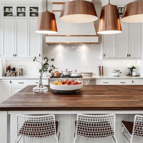 Copper and wood accents bring a warm and cozy feel to this beautiful white kitchen. Great look ...