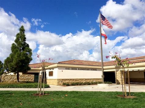 an american flag is flying in front of a building with a flag pole and flags