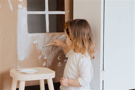 Girl Painting Cardboard House · Free Stock Photo