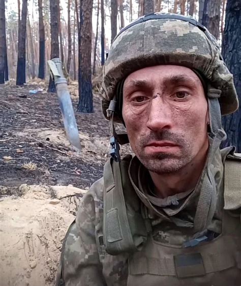 1000 Yard Stare: a very battle weary Ukrainian Army soldier, takes a photo with a Russian Grad ...