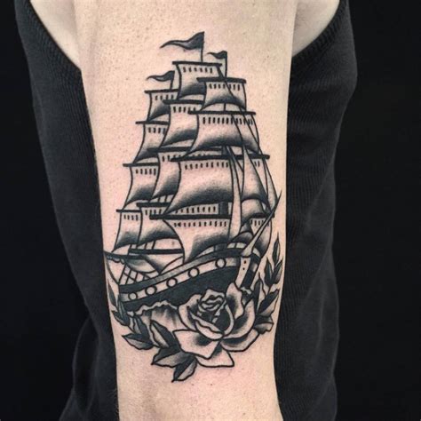 Traditional full-rigged ship tattoo on the right upper