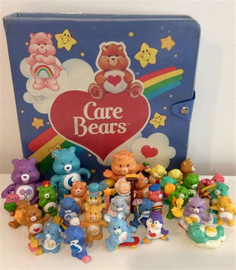 a group of care bears sitting next to each other in front of a blue box