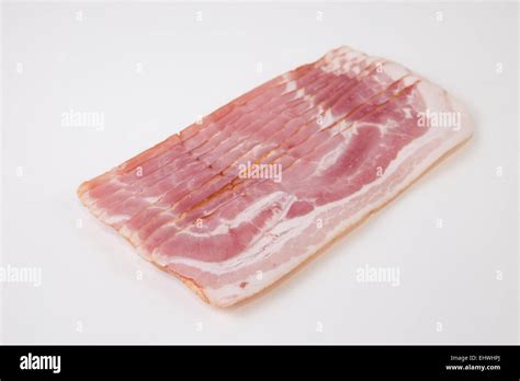 Raw bacon slices isolated on white background Stock Photo - Alamy